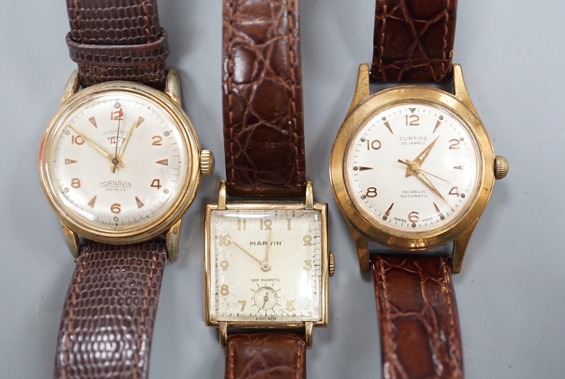 A gentleman's 1940's 9ct gold Marvin square dial manual wind wrist watch, on a later leather strap, together with two other gentleman's steel and gold plated wrist watches, Cornavin and Curtiss automatic.